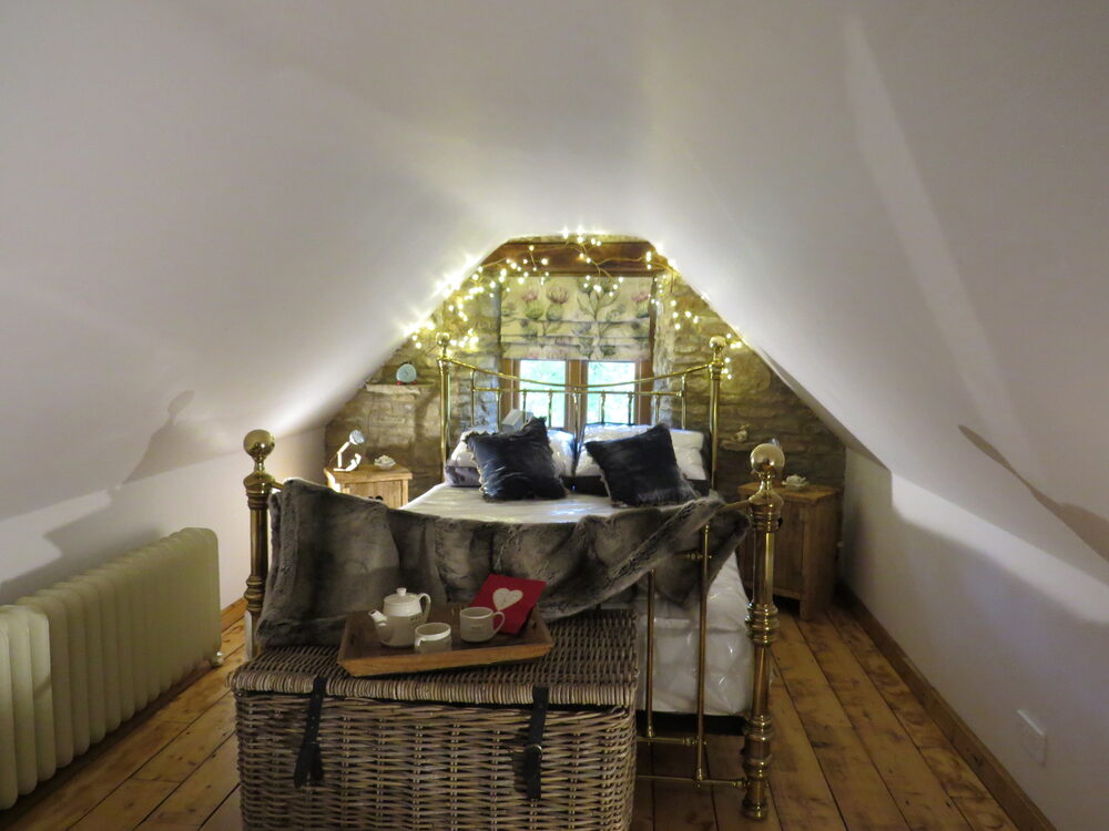 Brass bed with fairy lights